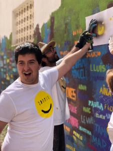 Toni, el alumno retratado en Artà, pintando su nombre en el mural