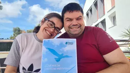 Jesús y Adriana personas que reciben apoyos en la asociación Vale, sosteniendo el manual en lectura facil de Reducción de prácticas restrictivas de Plena Inclusión. 
